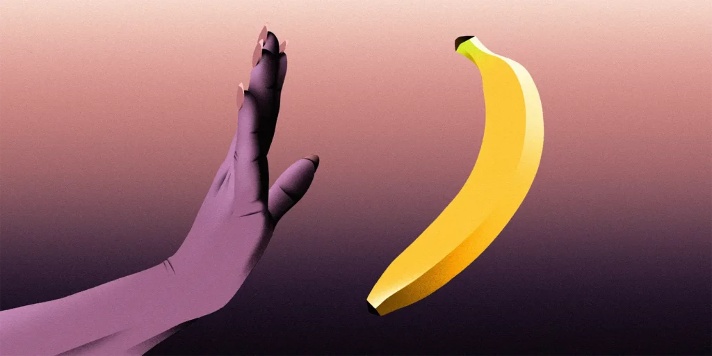 A Hand suggesting to stop towards a banana